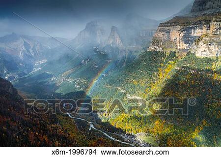 Picture - Mountains view and rainbow.. Fotosearch