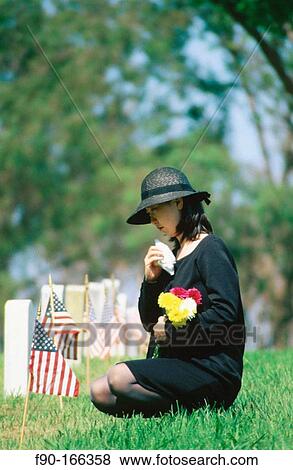 Mourning woman at grave site on memorial day View Large Photo Image Stock Photo - Mourning woman at grave site on memorial day. Fotosearch
