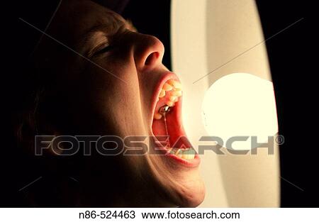 Stock Image - Mouth eating light bulb. Fotosearch