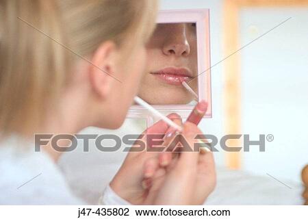 Mouth of girl putting lipstick on in a mirrror View Large Photo Image Stock Image - Mouth of girl putting lipstick on in a mirrror. Fotosearch