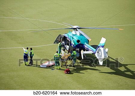 Moving of a patient in helicopter, emergency. Hospital de Zumarraga, Gipuzkoa, Euskadi. Spain. View Large Photo Image Picture - Moving of a patient in helicopter, emergency. Hospital de Zumarraga, Gipuzkoa, Euskadi. Spain.. Fotosearch