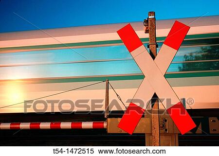 Moving train at level crossing View Large Photo Image Stock Photography - Moving train at level crossing. Fotosearch