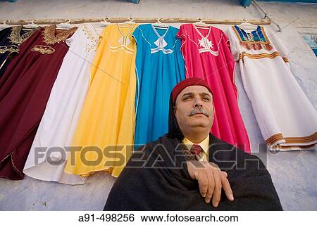 Mr Adel Saadani likes to be dressed as a Dandy. The Medina (ancient arabic city). Kairouan. Tunisia View Large Photo Image Stock Photograph - Mr Adel Saadani likes to be dressed as a Dandy. The Medina (ancient arabic city). Kairouan. Tunisia. Fotosearch