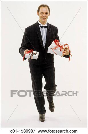 Mr Young man with black dress and presents View Large Photo Image Stock Photo - Mr Young man with black dress and presents. Fotosearch