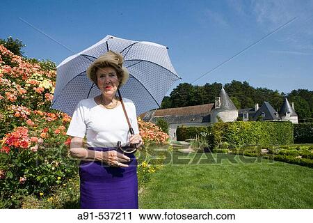 Stock Image - Mrs. B? atrice de Andia owner of La Chatonni? re castle and gardens near Azay-le-Rideau. Indre-et-Loire, France. Fotosearch