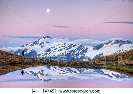 Mt Aspiring, tramper enjoys moonrise at dusk, Cascade Saddle tarn, Mount Aspiring National Park, Otago, New Zealand View Large Photo Image Stock Image - Mt Aspiring, tramper enjoys moonrise at dusk, Cascade Saddle tarn, Mount Aspiring National Park, Otago, New Zealand. Fotosearch