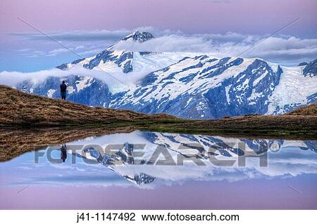 Mt Aspiring, tramper enjoys moonrise at dusk, Cascade Saddle tarn, Mount Aspiring National Park, Otago, New Zealand View Large Photo Image Stock Image - Mt Aspiring, tramper enjoys moonrise at dusk, Cascade Saddle tarn, Mount Aspiring National Park, Otago, New Zealand. Fotosearch