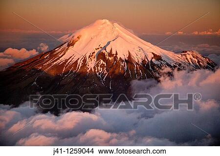 Mt Egmont / Taranaki, western flanks of dormant volcano above evening cloud, sunset, Taranaki. View Large Photo Image Picture - Mt Egmont / Taranaki, western flanks of dormant volcano above evening cloud, sunset, Taranaki.. Fotosearch