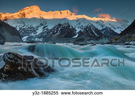 Stock Photography - Mt Sefton at dawn, outflow river from Mueller Lake, Aoraki Mount Cook National Park, Canterbury. Fotosearch