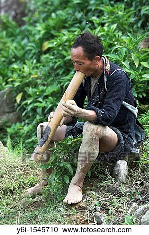 Mud splattered farmer takes break from ploughing rice terraces to smoke traditional pipe near Sapa Vietnam View Large Photo Image Stock Image - Mud splattered farmer takes break from ploughing rice terraces to smoke traditional pipe near Sapa Vietnam. Fotosearch