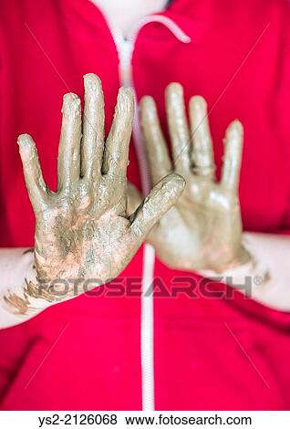 Muddy hands of woman working with pottery. Close up of the clay covered palms. View Large Photo Image Stock Photo - Muddy hands of woman working with pottery. Close up of the clay covered palms.. Fotosearch