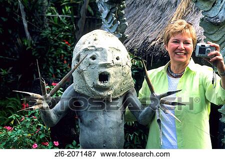 Mudman of Papua New Guinea Tacking Picture With Tourist. View Large Photo Image Stock Photo - Mudman of Papua New Guinea Tacking Picture With Tourist.. Fotosearch