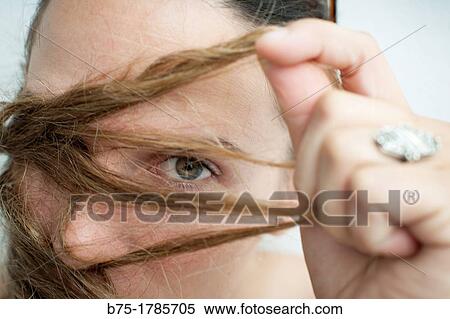 Mujer con mirada intrigante y pelo parcialmente delante de la cara, Woman with look intriguing and hair infront part of the face, View Large Photo Image Stock Photography - Mujer con mirada intrigante y pelo parcialmente delante de la cara, Woman with look intriguing and hair infront part of the face,. Fotosearch
