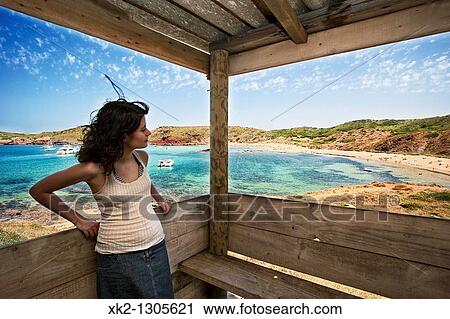 Mujer disfrutando del paisaje de la playa de Cavalleria, Menorca, Islas Baleares View Large Photo Image Stock Image - Mujer disfrutando del paisaje de la playa de Cavalleria, Menorca, Islas Baleares. Fotosearch