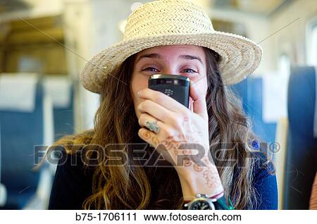 mujer joven con sombrero y telefono movil en la mano, young woman with hat and mobile phone in hand, View Large Photo Image Stock Image - mujer joven con sombrero y telefono movil en la mano, young woman with hat and mobile phone in hand,. Fotosearch