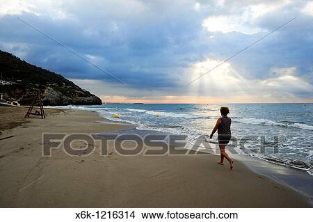 Mujer paseando por la playa del Garraf, Garraf, Provincia de Barcelona, Catalunya, Espaa View Large Photo Image Picture - Mujer paseando por la playa del Garraf, Garraf, Provincia de Barcelona, Catalunya, Espaa. Fotosearch