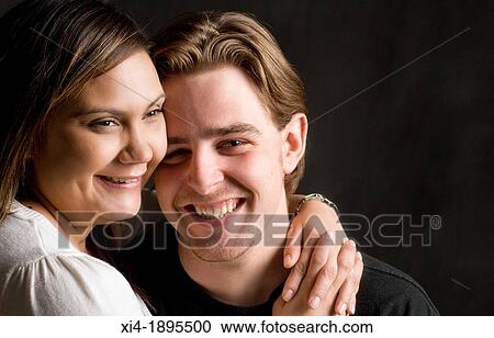 Multicultural couple portrait against black background View Large Photo Image Stock Image - Multicultural couple portrait against black background. Fotosearch