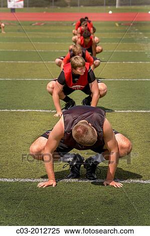 Multiethnic high school athletes limber up with flexibility exercises as they begin spring football practice in San Clemente, CA. High school athletes limber up with flexibility exercises as they begin spring football practice in San Clemente, CA. View Large Photo Image Stock Photography - Multiethnic high school athletes limber up with flexibility exercises as they begin spring football practice in San Clemente, CA. High school athletes limber up with flexibility exercises as they begin spring football practice in San Clemente, CA.. Fotosearch