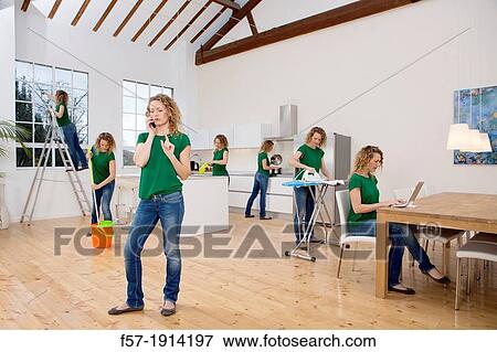 Multitasking woman takes on all the household chores View Large Photo Image Stock Photo - Multitasking woman takes on all the household chores. Fotosearch