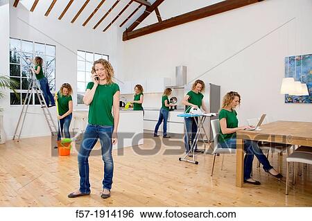 Multitasking woman takes on all the household chores View Large Photo Image Stock Photograph - Multitasking woman takes on all the household chores. Fotosearch
