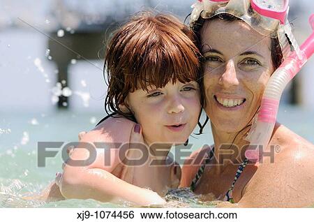 Stock Photograph - Mum and baby swim together. Fotosearch