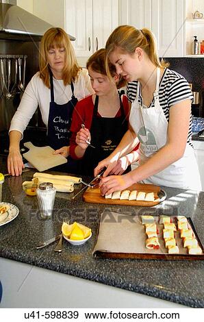 mum teaching cooking to teenage girls View Large Photo Image Stock Photo - mum teaching cooking to teenage girls. Fotosearch