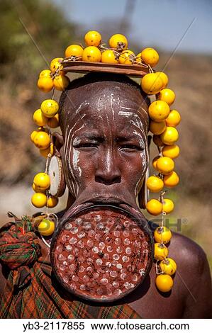 Mursi Woman Wearing A Lip Plate, Mursi Tribal Village, The Omo Valley, Ethiopia. View Large Photo Image Stock Photography - Mursi Woman Wearing A Lip Plate, Mursi Tribal Village, The Omo Valley, Ethiopia.. Fotosearch