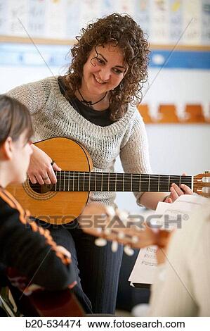 Music teacher, guitar instruction View Large Photo Image Picture - Music teacher, guitar instruction. Fotosearch