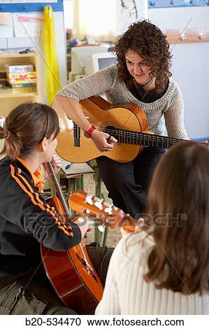 Music teacher, guitar instruction View Large Photo Image Stock Image - Music teacher, guitar instruction. Fotosearch