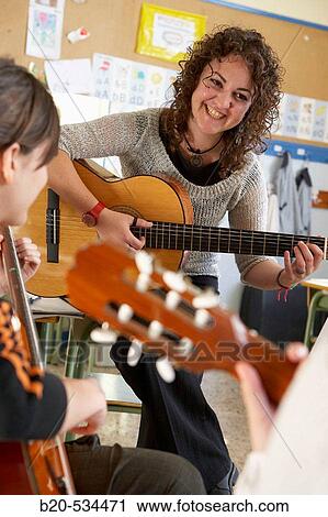 Music teacher, guitar instruction View Large Photo Image Stock Image - Music teacher, guitar instruction. Fotosearch
