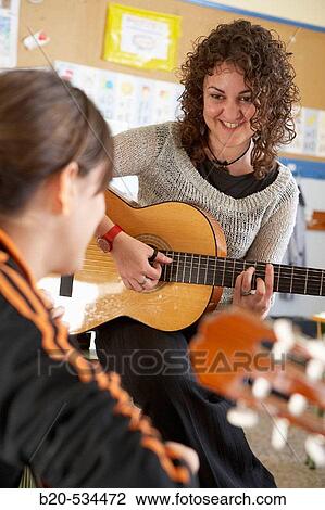 Music teacher, guitar instruction View Large Photo Image Stock Image - Music teacher, guitar instruction. Fotosearch