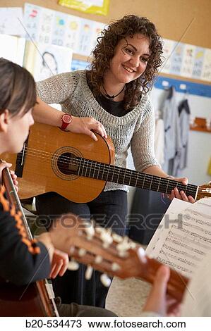 Music teacher, guitar instruction View Large Photo Image Stock Image - Music teacher, guitar instruction. Fotosearch