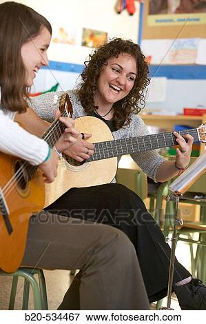 Music teacher, guitar instruction View Large Photo Image Stock Photo - Music teacher, guitar instruction. Fotosearch
