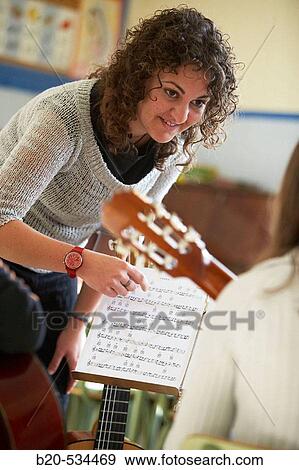 Music teacher, guitar instruction View Large Photo Image Stock Photo - Music teacher, guitar instruction. Fotosearch