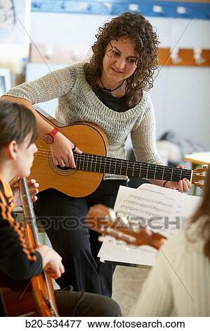 Music teacher, guitar instruction View Large Photo Image Stock Photo - Music teacher, guitar instruction. Fotosearch