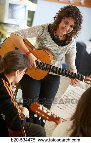 Music teacher, guitar instruction View Large Photo Image Stock Photography - Music teacher, guitar instruction. Fotosearch
