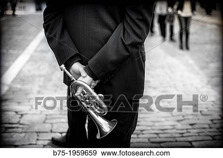 Musician back with trumpet in hand View Large Photo Image Stock Photo - Musician back with trumpet in hand. Fotosearch