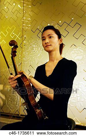 Musician girl at the Okura Garden Hotel, Shanghai, China. View Large Photo Image Stock Image - Musician girl at the Okura Garden Hotel, Shanghai, China.. Fotosearch