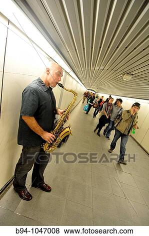 Stock Photo - Musician playing the saxophone in the corridors of subway station, Barcelona, Catalonia, Spain. Fotosearch