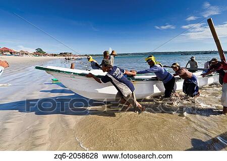 Stock Photo - Muslim Fishermen at work in Jimbaran on Bali, Indonesia.. Fotosearch