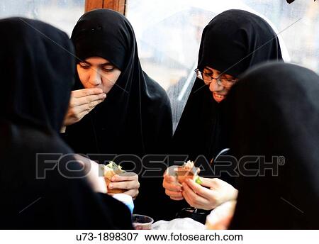 Muslim girls eating fish sandwiches by the Galata bridge in Istanbul View Large Photo Image Stock Photo - Muslim girls eating fish sandwiches by the Galata bridge in Istanbul. Fotosearch