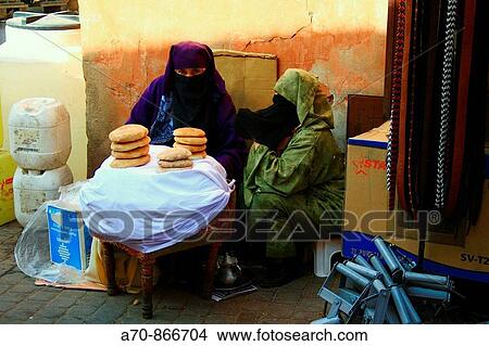 Muslim with veil sells Fladenbrot in the Medina of Marrakesch (Souk) View Large Photo Image Picture - Muslim with veil sells Fladenbrot in the Medina of Marrakesch (Souk). Fotosearch