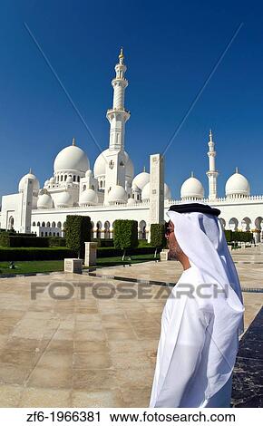 Muslimm Emirates man in white dishelash at the beautiful white Sheikh Zayed Grand Mosque in Abu Dhabi in the UAE the worlds 8th largest Muslim mosque in the world. View Large Photo Image Stock Image - Muslimm Emirates man in white dishelash at the beautiful white Sheikh Zayed Grand Mosque in Abu Dhabi in the UAE the worlds 8th largest Muslim mosque in the world.. Fotosearch