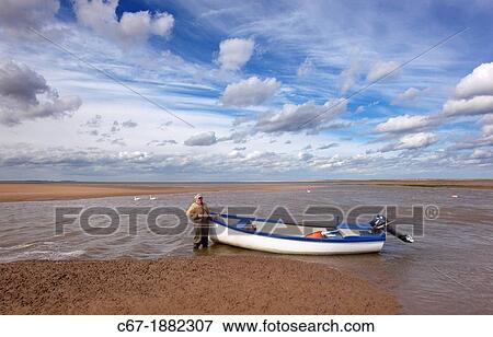 Mussels fisherman returning on river Stffkey in Blakeney Harbour Norfolk September View Large Photo Image Stock Photo - Mussels fisherman returning on river Stffkey in Blakeney Harbour Norfolk September. Fotosearch