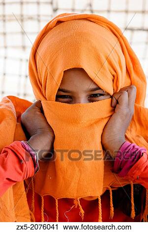 Muzzeina tribe bedouin girl hiding her face with a headscarf - Sinai Peninsula, Egypt. View Large Photo Image Stock Image - Muzzeina tribe bedouin girl hiding her face with a headscarf - Sinai Peninsula, Egypt.. Fotosearch