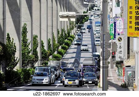 Stock Photo - Naha Okinawa, Japan, city traffic by Shiritsu Byoin-mae monorail station. Fotosearch