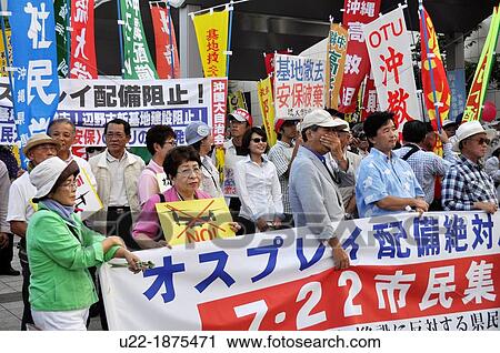 Naha, Okinawa, Japan, people gathering in front of Okinawa Prefecture to protest against the American military occupation of Okinawa, the use of V-22 Osprey helicopters and the desctrucion of Yanbaru forest near Takae village View Large Photo Image Stock Image - Naha, Okinawa, Japan, people gathering in front of Okinawa Prefecture to protest against the American military occupation of Okinawa, the use of V-22 Osprey helicopters and the desctrucion of Yanbaru forest near Takae village. Fotosearch