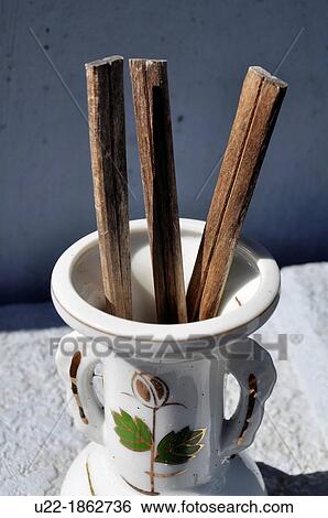 Stock Photograph - Naha Okinawa, Japan, Shikina Cemetery, chopsticks by a grave, left for the dead. Fotosearch