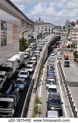 Stock Image - Naha, Okinawa, Japan, view of the city in Asato neighborhood, by the monorail track. Fotosearch