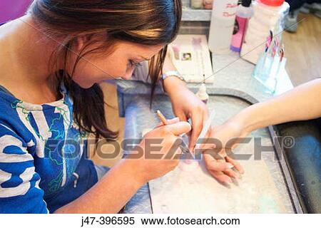 Nail therapist doing nails in a salon View Large Photo Image Stock Photography - Nail therapist doing nails in a salon. Fotosearch